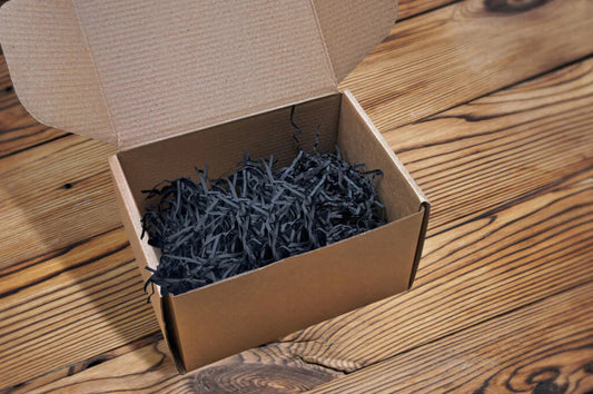 A box with shredded kraft paper inside used to protect the contents that will be put inside the box