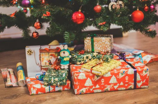 Christmas Presents wrapped up under a christmas tree