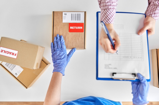 A delivery person waiting whilst a customer signs paperwork to complete a return which highlights the damaging effect on e-commerce due to the higher return rates