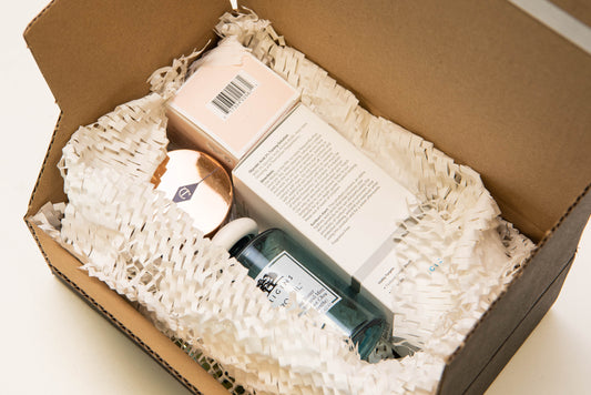 A package with luxury beauty items being protected by paper void fill.